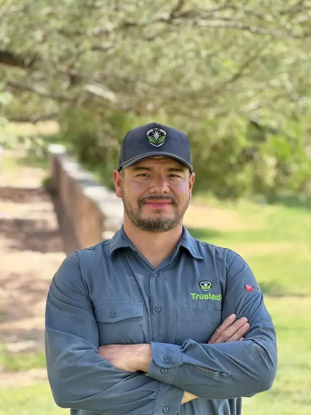 Valentin Moriel, owner of Trusted Termite and Pest Solutions, in a company shirt and cap